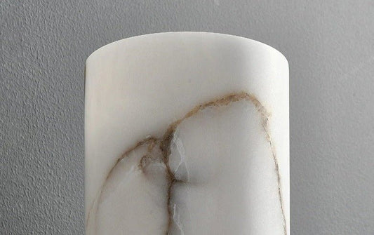 Marble-patterned cylindrical object against a gray background